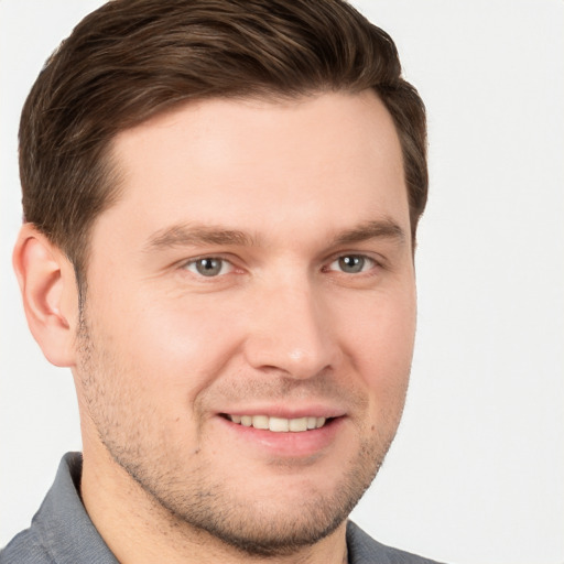 Joyful white young-adult male with short  brown hair and brown eyes