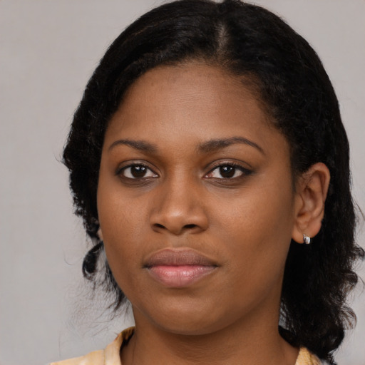 Joyful black young-adult female with medium  black hair and brown eyes