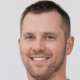 Joyful white adult male with short  brown hair and brown eyes