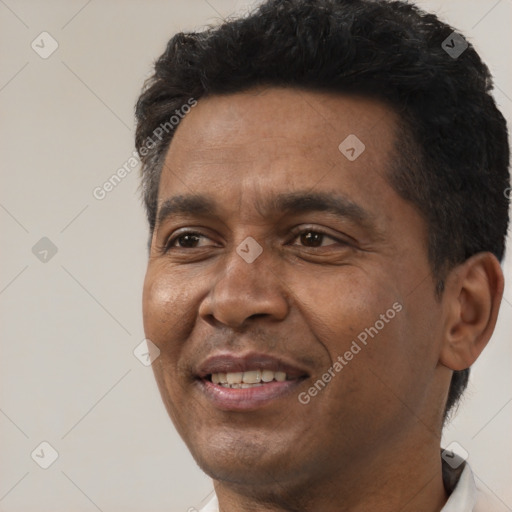 Joyful white adult male with short  black hair and brown eyes