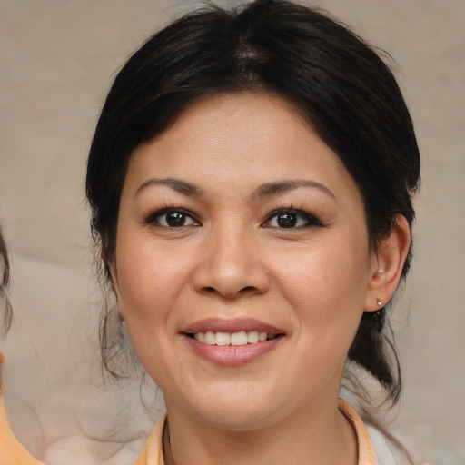 Joyful asian adult female with medium  brown hair and brown eyes