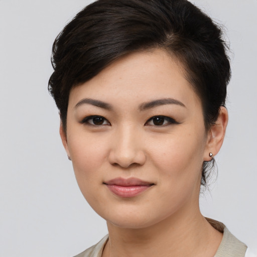 Joyful asian young-adult female with medium  black hair and brown eyes