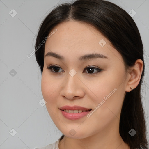 Joyful asian young-adult female with medium  brown hair and brown eyes