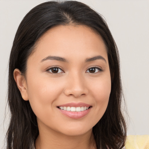 Joyful white young-adult female with long  brown hair and brown eyes