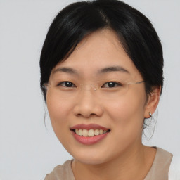 Joyful asian young-adult female with medium  black hair and brown eyes