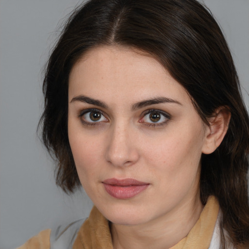 Joyful white young-adult female with medium  brown hair and brown eyes