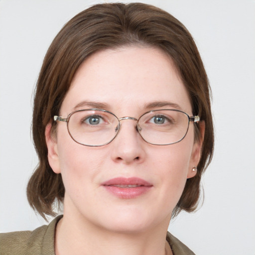 Joyful white young-adult female with medium  brown hair and blue eyes