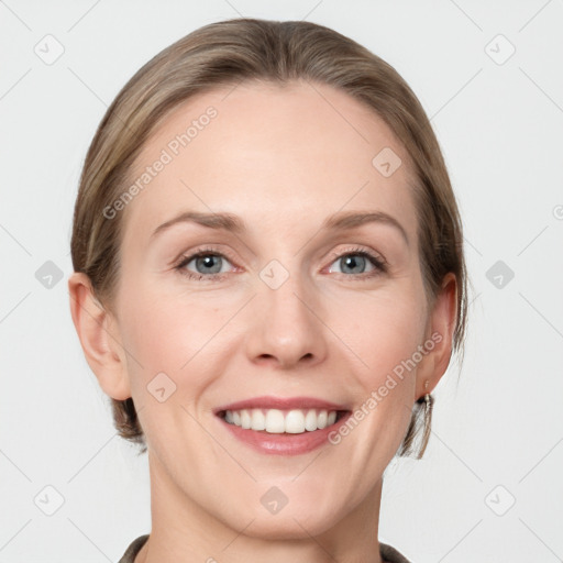 Joyful white adult female with medium  brown hair and grey eyes