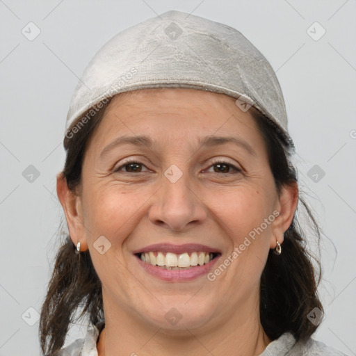 Joyful white adult female with medium  brown hair and brown eyes