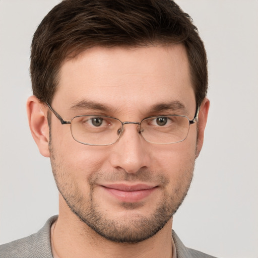 Joyful white adult male with short  brown hair and grey eyes