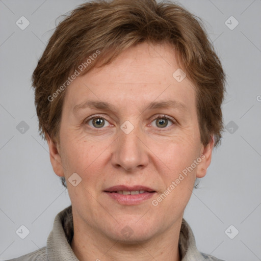 Joyful white adult female with short  brown hair and grey eyes