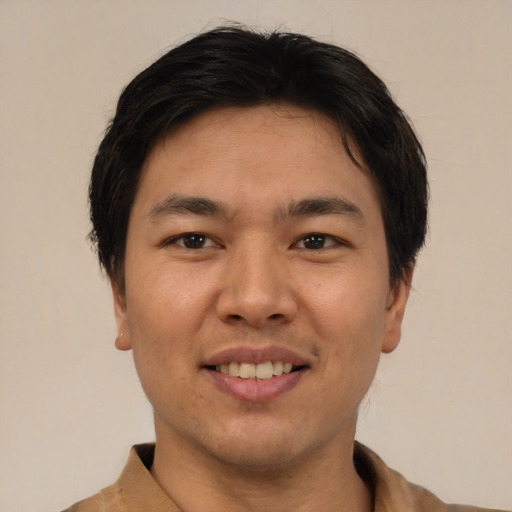 Joyful asian young-adult male with short  black hair and brown eyes