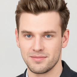 Joyful white young-adult male with short  brown hair and grey eyes