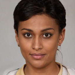 Joyful latino young-adult female with short  brown hair and brown eyes