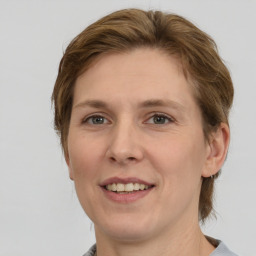 Joyful white adult female with medium  brown hair and grey eyes