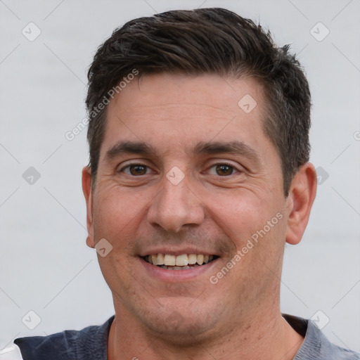 Joyful white adult male with short  brown hair and brown eyes