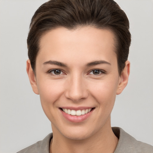 Joyful white young-adult female with short  brown hair and brown eyes