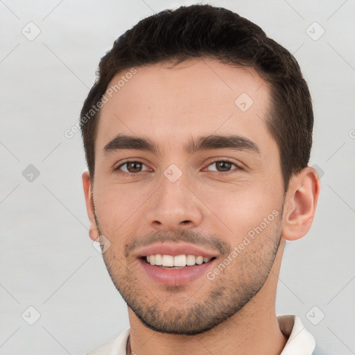 Joyful white young-adult male with short  brown hair and brown eyes