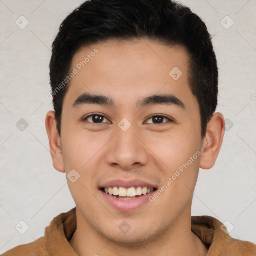 Joyful latino young-adult male with short  brown hair and brown eyes