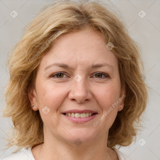 Joyful white adult female with medium  brown hair and blue eyes