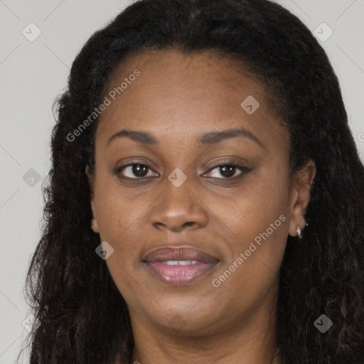 Joyful black adult female with long  brown hair and brown eyes