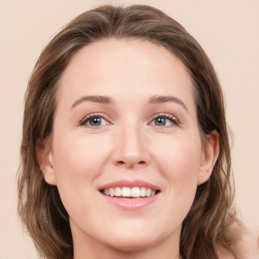 Joyful white young-adult female with medium  brown hair and grey eyes