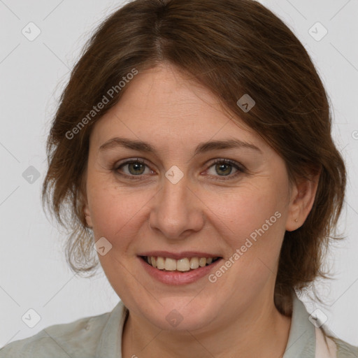 Joyful white adult female with medium  brown hair and grey eyes