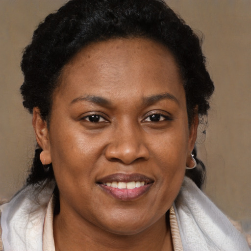Joyful black adult female with medium  brown hair and brown eyes