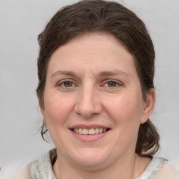 Joyful white adult female with medium  brown hair and grey eyes