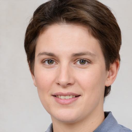 Joyful white young-adult female with short  brown hair and grey eyes