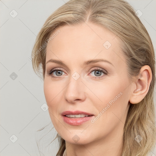 Joyful white young-adult female with long  brown hair and blue eyes