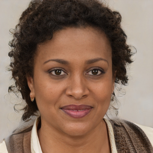 Joyful black young-adult female with medium  brown hair and brown eyes