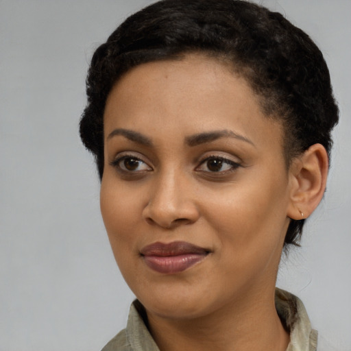 Joyful latino young-adult female with short  black hair and brown eyes