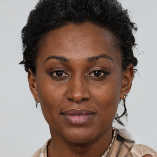 Joyful black adult female with short  brown hair and brown eyes