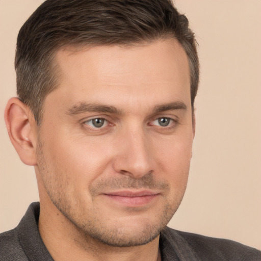 Joyful white young-adult male with short  brown hair and brown eyes