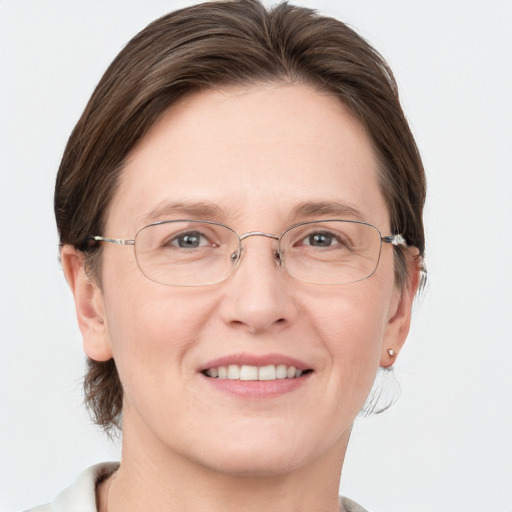 Joyful white adult female with medium  brown hair and grey eyes