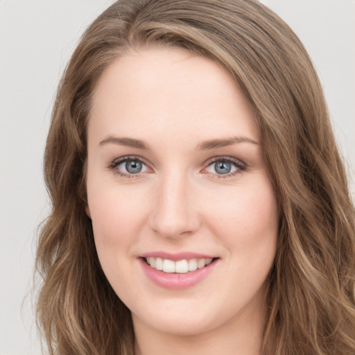 Joyful white young-adult female with long  brown hair and green eyes