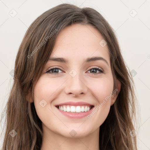 Joyful white young-adult female with long  brown hair and green eyes