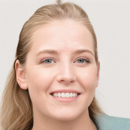 Joyful white young-adult female with long  brown hair and blue eyes