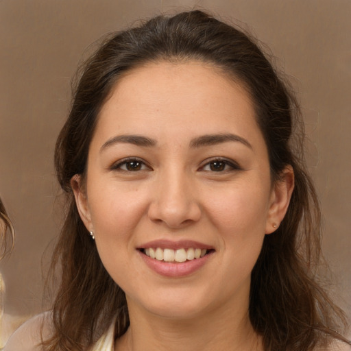 Joyful white young-adult female with long  brown hair and brown eyes