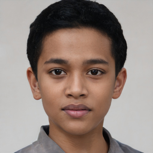 Joyful latino child male with short  black hair and brown eyes