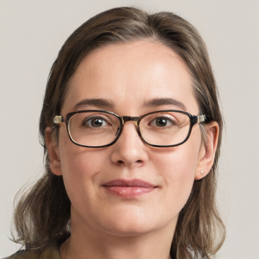 Joyful white young-adult female with medium  brown hair and grey eyes