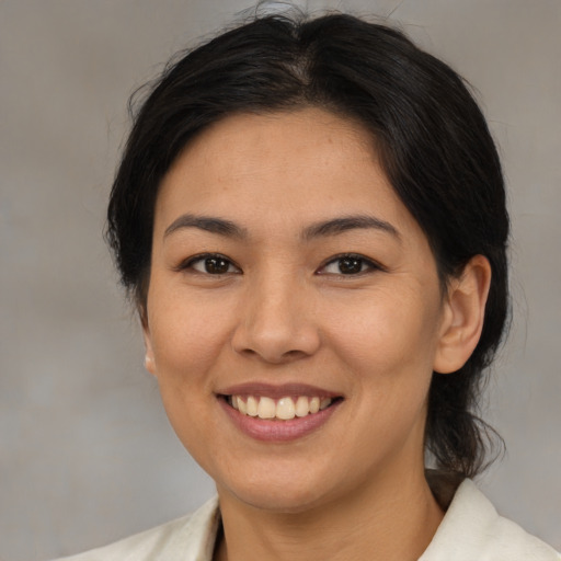 Joyful asian young-adult female with medium  brown hair and brown eyes