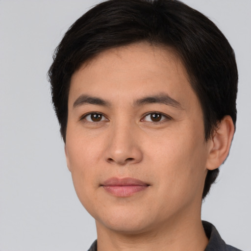 Joyful asian young-adult male with short  brown hair and brown eyes