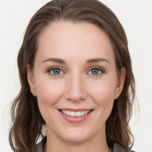 Joyful white young-adult female with long  brown hair and grey eyes