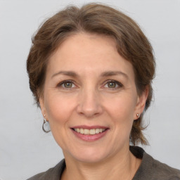 Joyful white adult female with medium  brown hair and grey eyes