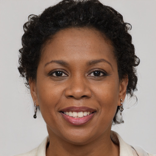 Joyful black adult female with medium  brown hair and brown eyes