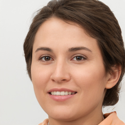 Joyful white young-adult female with medium  brown hair and brown eyes