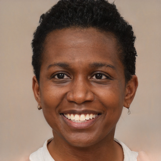 Joyful black young-adult female with short  brown hair and brown eyes