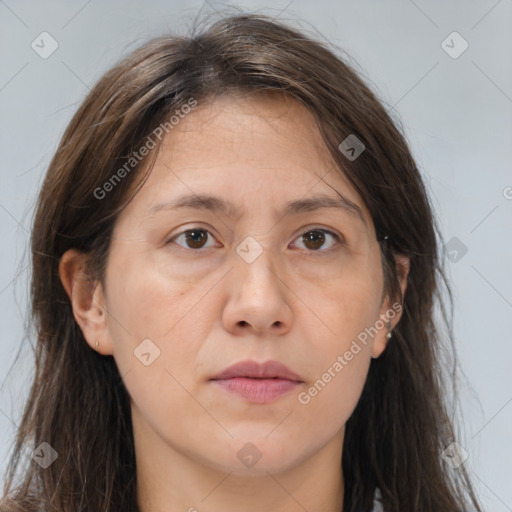 Joyful white adult female with long  brown hair and brown eyes